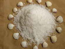 Sea Salt Surrounded By Shells On Brown Background