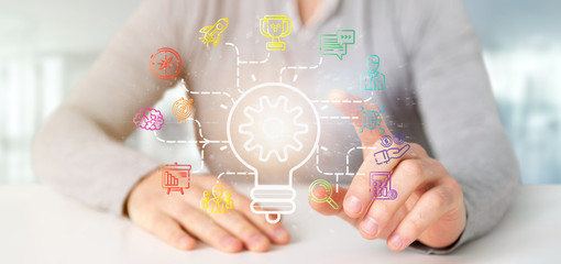 Poster - Businessman holding a Bulb lamp idea concept with start up icon connected 3d rendering