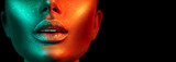 Fototapeta  - Fashion model woman face in bright sparkles, colorful neon lights, beautiful sexy girl lips. Trendy glowing gold skin make-up. Glitter metallic shine makeup