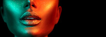 Fashion Model Woman Face In Bright Sparkles, Colorful Neon Lights, Beautiful Sexy Girl Lips. Trendy Glowing Gold Skin Make-up. Glitter Metallic Shine Makeup