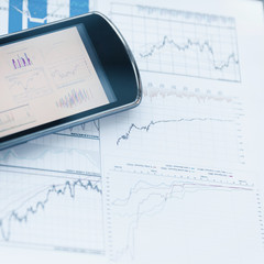 Wall Mural - mobile phones and charts of financial growth on the desktop