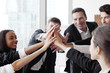 © alotofpeople - Business team making high five
