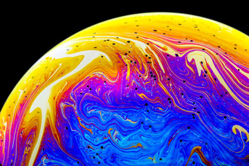 Wall Mural - multicolored rainbow colors of a single soap bubble that looks like a fantasy planet isolated agains