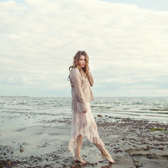 Romantic beauty portrait of beautiful woman outdoors on ocean coast