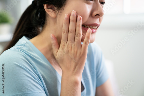 Young Asian Girl With Toothache And Dental Problems Japanese Casual Woman Hands Touching Face Feeling Sensitive Teeth Inside Frowning Unhappy Discomfort Wife Illness Indoors In Blue T Shirt Stock Photo Adobe