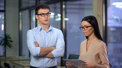 Wall Mural - Nervous secretary holding documents feeling scared of male boss, office work