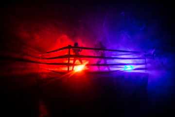 Wall Mural - Man and woman boxing on the ring. Sport concept. Artwork decoration with foggy toned dark background.