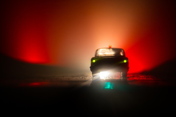 Wall Mural - Police cars at night. Police car chasing a car at night with fog background. 911 Emergency response