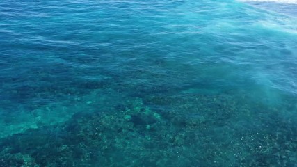 Wall Mural - waves and azure water as a background. view from high rock at the ocean surface. natural summer seas