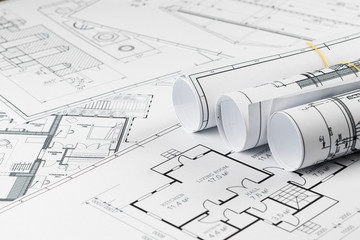 Architectural construction drawings twisted into a roll, construction projects on paper. The concept of architecture, construction, engineering. Copy space.