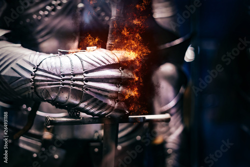 Fotografía Close up of a Medieval steel armour with iron glove hand bursting with flames of