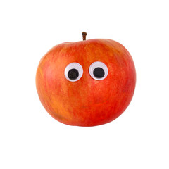 Googly eyes. Funny cute red ripe apple with toy eyes, isolated on white background.