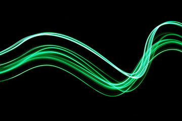 Wall Mural - Long exposure, light painting photography.  Vibrant waves of neon green color against a black background.