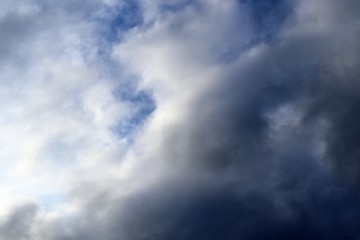 Dark forming clouds with blue sky elements right before a thunderstorm