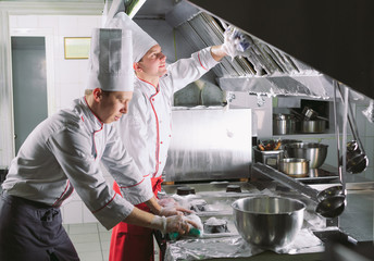 Sanitary day in the restaurant. Repeats wash your workplace. Cooks wash oven, stove and extractor in the Restaurant.