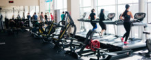 Blurred Photo Of A Gym With People On Treadmills