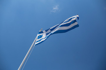 greek flag waving on blue sky clouds greece