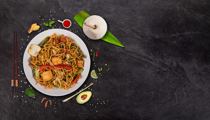 Vegetarian tofu asian food background with various ingredients on rustic stone table.