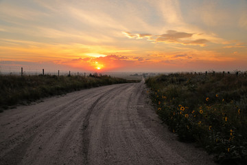 Wall Mural - Dirt road at sunrise, North Platte River valley, western Nebraska, USA