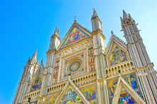 View Of The Orvieto Cathedral With Beautiful Sculptures And Painting On The Facade In Orvieto, Italy.