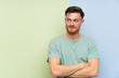 © luismolinero - Redhead man over colorful background standing and looking to the side
