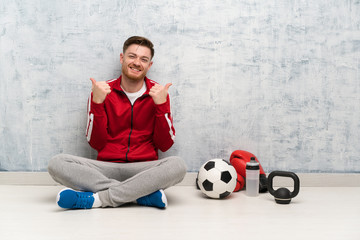 Wall Mural - Redhead sport man with thumbs up gesture and smiling