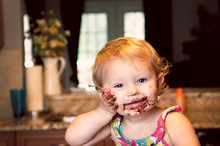 Happy Toddler Girl With Messy Chocolate Face 