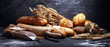 Leinwandbild Motiv Assortment of baked bread and bread rolls on rustic black bakery table background