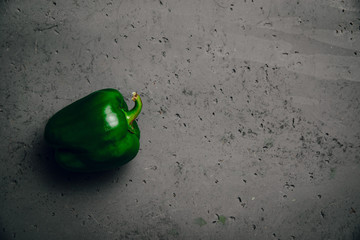 Green peppers on a stone counter top. Green pepper ready to cook. Peppers lie on a countertop, the concept of cooking and preparing a meal.