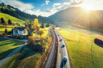 Wall Mural - aerial view of the road in mountain valley at sunset in spring in dolomites, italy. top view of cars