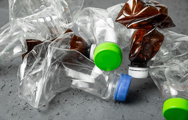 Poster - A plastic bottles on a stone countertop background. Concept of caring for the environment, recycling. Secondary plastic circuit. Environment pollution.