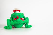 Happy Green Frog Doll On Color Background. Isolated, Green, Red, White.