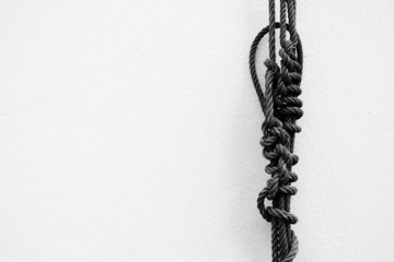 Rope with White Cool Concrete Wall Texture Background.