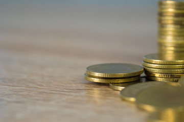 Columns of gold coins, piles of coins on working table, business banking and financial concept.