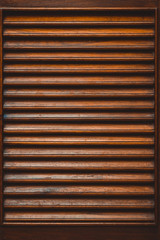 Wall Mural - Wooden slatted fence or lath front showcase cabinet or wardrobe, frame door and drawers made from dark wood, background and texture, interior design.