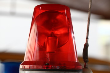 A flashing light and a loudspeaker on a police car.