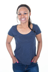 Smiling African girl with hands in jeans casual