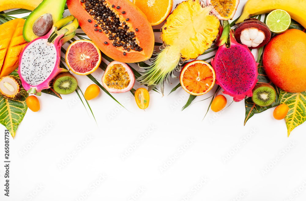 Still life with fresh assorted exotic fruits on a palm leaf. - obrazy, fototapety, plakaty 