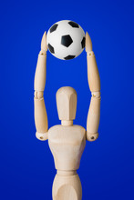 Football Wooden Toy Figure On Blue