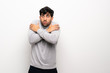 © luismolinero - Young man over isolated white wall freezing