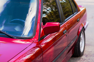 Wall Mural - Rearview mirror on a red old car