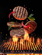 Beef Milled Meat On Hamburger With Spices Fly Over The Flaming Grill Barbecue Fire.