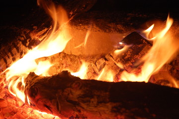 Bonfire with sparks flying around. Flame amd fire sparks on dark abstract background