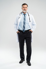 Full body portrait of happy smiling doctor, isolated on white background.