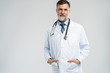 © opolja - Cheerful mature doctor posing and smiling at camera, healthcare and medicine.