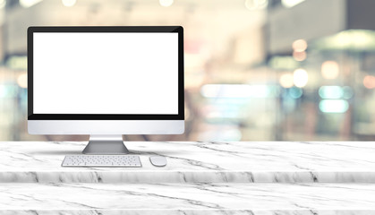 Fototapete - Blank screen of desktop computer on step white marble table with blur restaurant at background,Mock up template for display of design,Banner for advertise