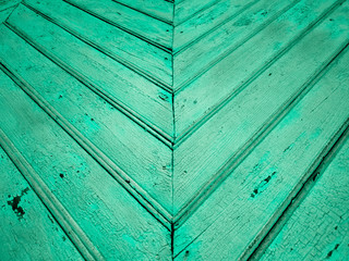 Old green boards. Green wooden fence. The wall is green wooden.