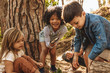 © Jacob Lund - Cute kids with magnifying glass in forest