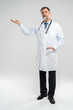 © opolja - Doctor senior man, medical professional holding something in empty hand isolated over white background.