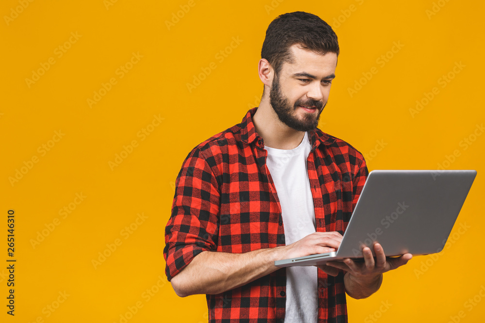 Concentrated on work. Confident young handsome man in casual working on ...